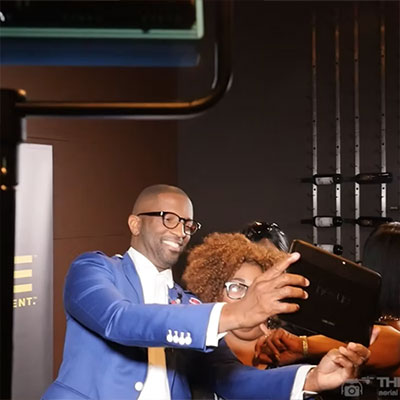 Rickey Smiley taking a photo with a fan