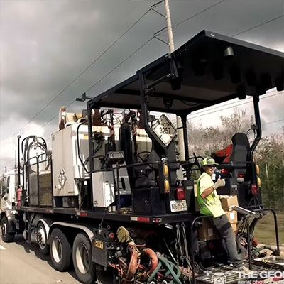 A man riding on the back of a truck